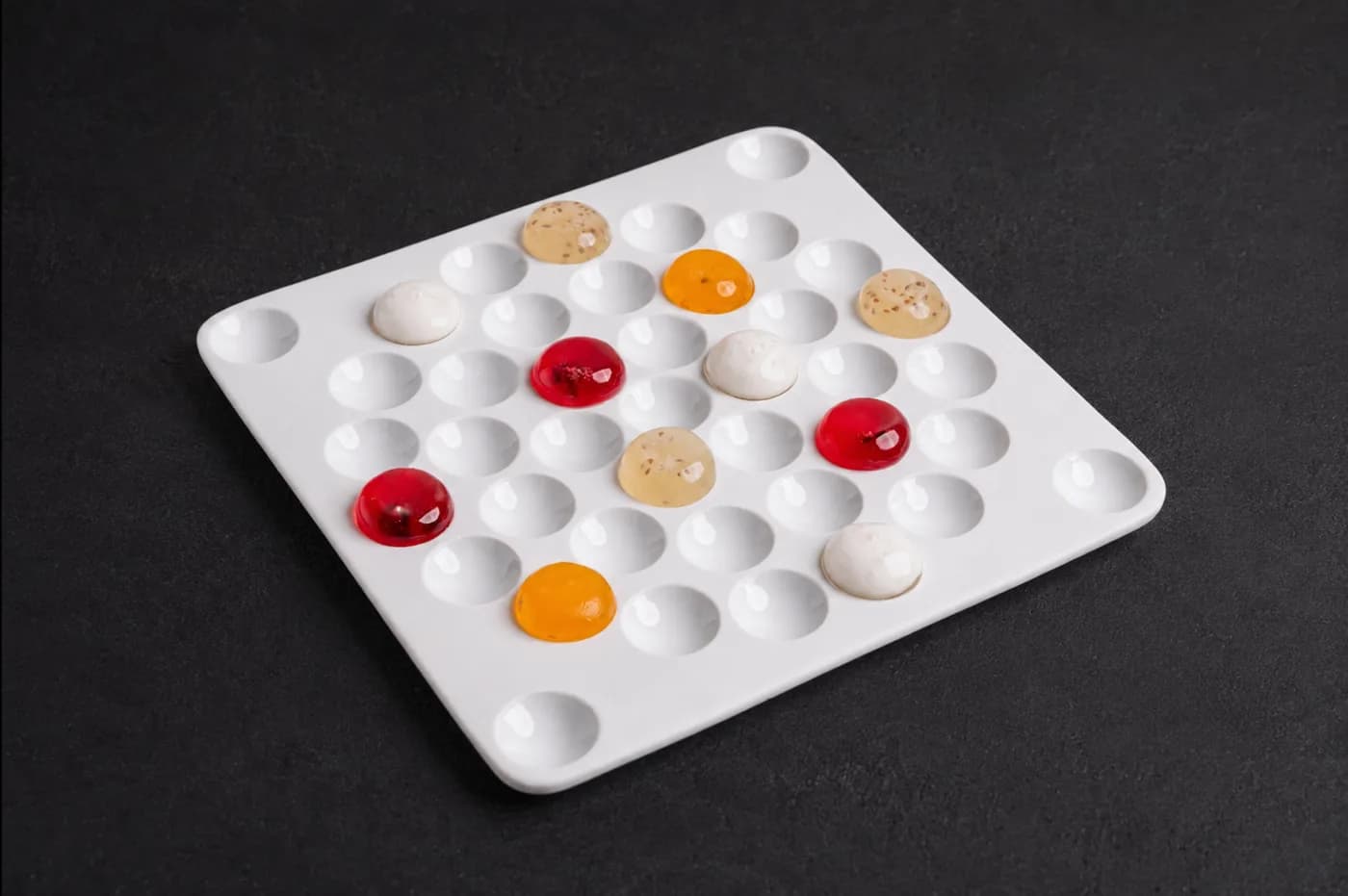 A colour study of jewel-like bites on white ceramic